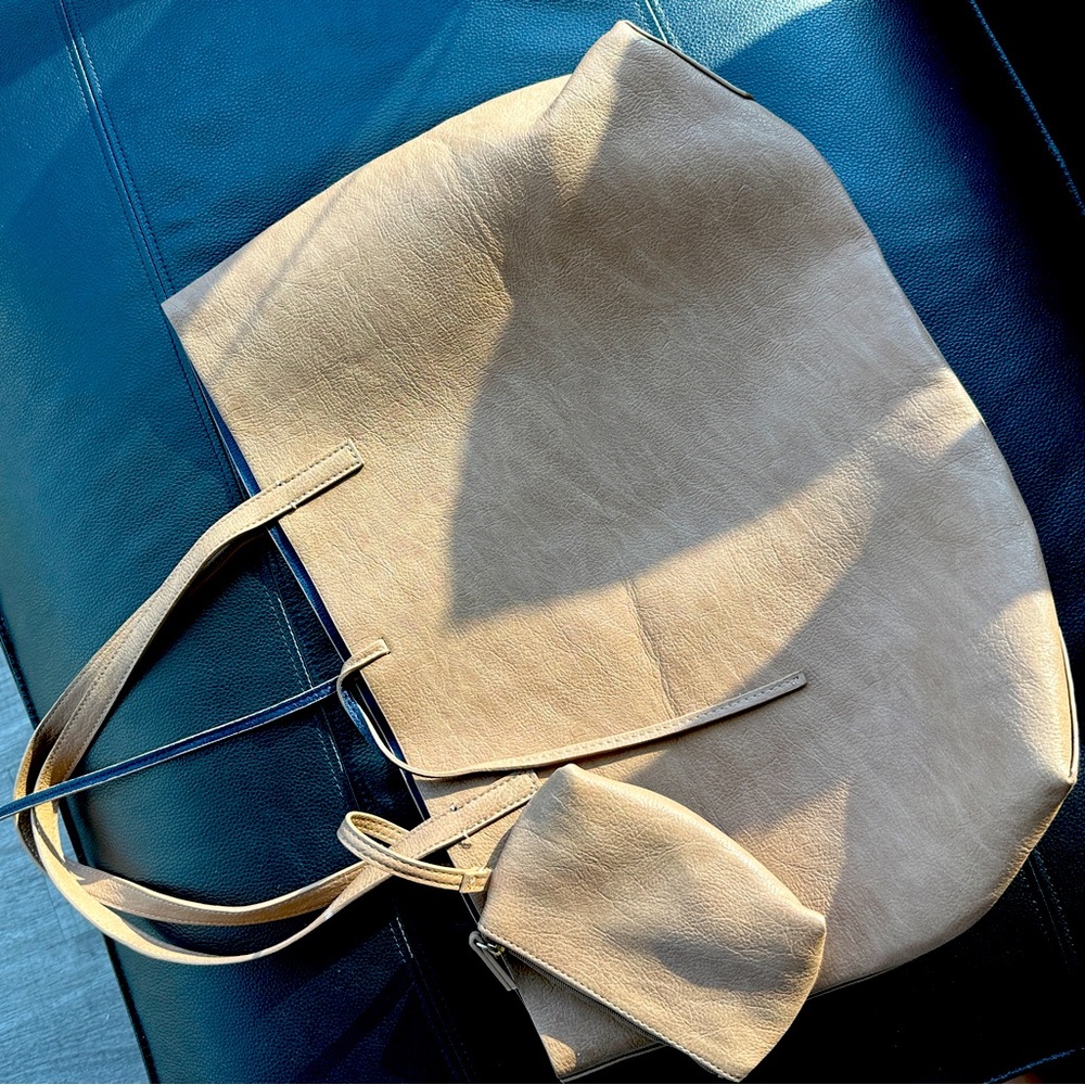 Leather tote bag with roomy capacity.nice color brown tan, never used